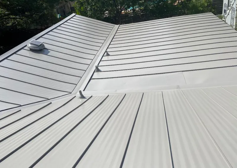 Solar attic fan installed on a metal roof for Roof Ventilation in Reedurban